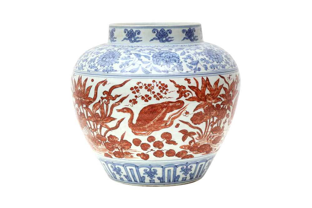 A CHINESE COPPER RED-ENAMELLED BLUE AND WHITE 'LOTUS POND' JAR 或為明 青花紅料蓮池罐