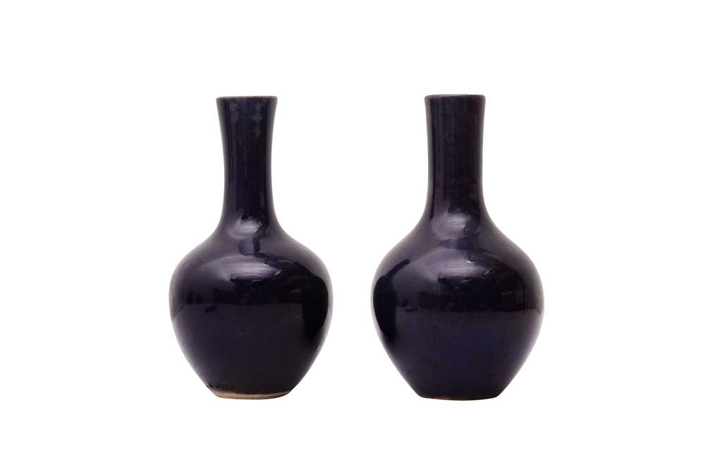 TWO SMALL CHINESE MONOCHROME BLUE-GLAZED VASES 清十八世紀 藍釉長頸撇口瓶及藍釉長頸瓶