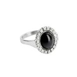 AN ONYX AND DIAMOND CLUSTER RING