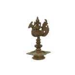 A FINE SOUTH INDIAN BRONZE OIL LAMP WITH A HINDU GODDESS SEATED ON A HAMSA BIRD Possibly South India