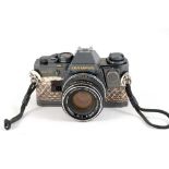 A "Gun Metal" Olympus OM10 with Snake Skin Style Covering.
