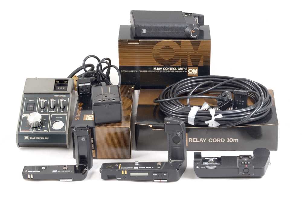 A Group of Olympus Motor Drives & Chargers.
