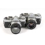 A Pair of Chrome Olympus OM-1 Cameras.