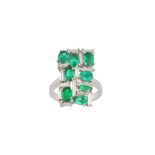 An emerald and diamond dress ring