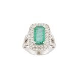 An emerald and diamond cluster ring