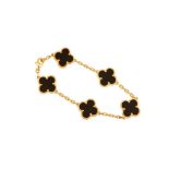 Van Cleef & Arpels | A gold and onyx 'Alhambra' bracelet