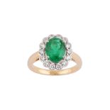 An emerald and diamond cluster ring