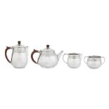 A George V ‘Arts and Crafts’ sterling silver four-piece tea and coffee service, Birmingham 1935 by A