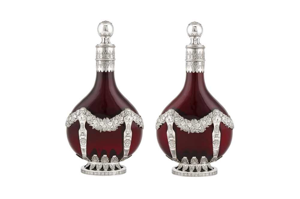 A pair of late 19th century German 800 standard silver mounded ruby glass decanters, Kesselstadt cir