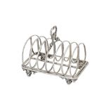 A Victorian sterling silver seven bar toast rack, London 1843 by messrs Barnard