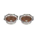 A pair of George IV sterling silver wine coasters, Sheffield 1826 by John and Thomas Settle