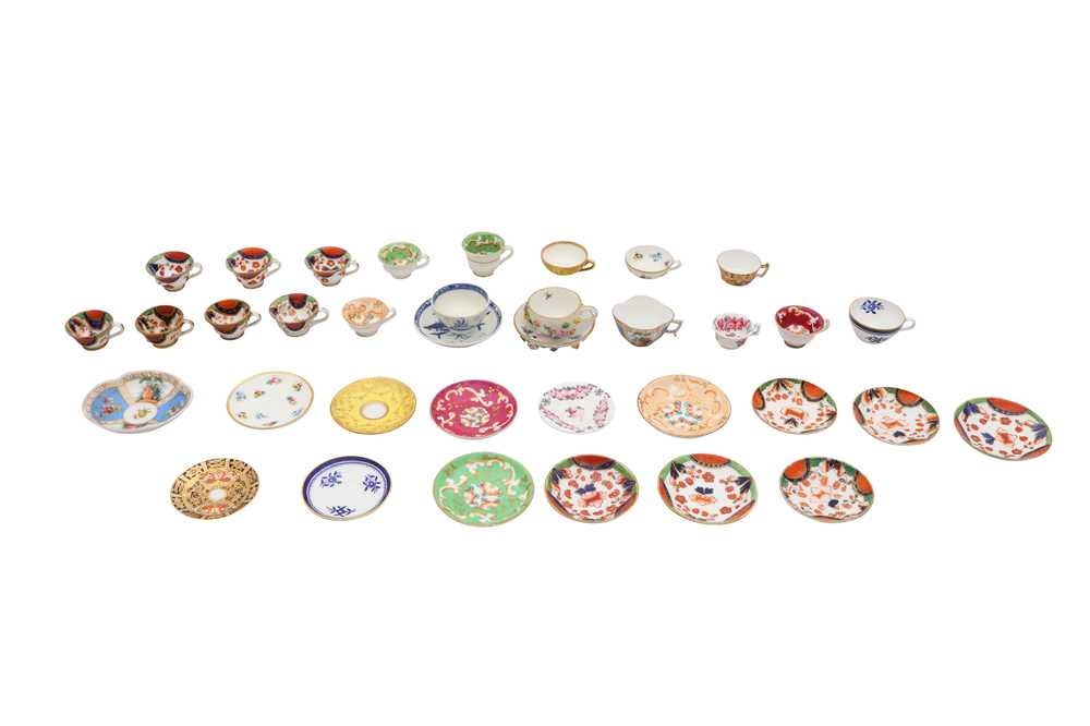 A GROUP OF PORCELAIN MINIATURE TEACUPS AN SAUCERS