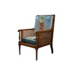 A REGENCY STYLE MAHOGANY AND LINE INLAID BERGERE ARMCHAIR, LATE 19TH CENTURY