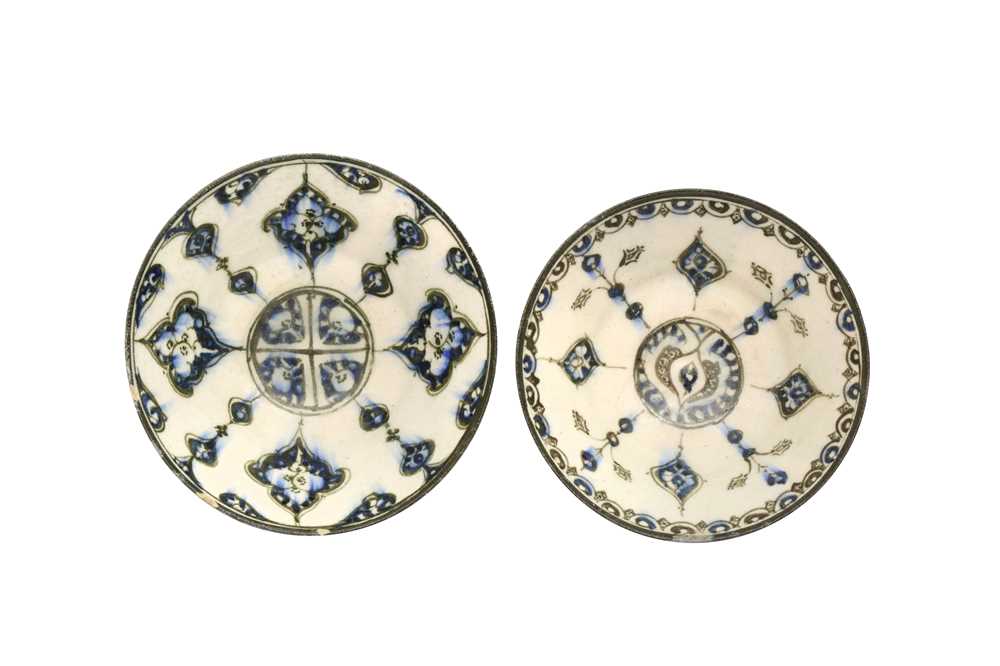 A NEAR PAIR OF COBALT BLUE AND BLACK-PAINTED POTTERY BOWLS WITH ARABESQUE MOTIFS Kashan, Iran, ca. 1