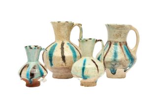 FOUR SMALL SELJUK SPLASHED POTTERY JUGS Iran or Afghanistan, 12th - 13th century