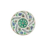 AN IZNIK POTTERY SAUCER WITH TULIPS, ROSETTES, AND BLUE HYACINTHS Ottoman Turkey, ca. 1560 - 1580