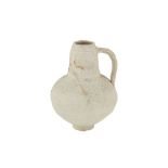 AN UNGLAZED POTTERY JUG WITH INCISED DECORATION Possibly Syria, 12th - 13th century