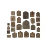 TWENTY-FIVE BRASS DECORATIVE MOULDS FOR TALISMANS WITH HINDU DEITIES Northern and Eastern India, 19t