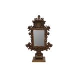 AN UNUSUAL 18TH CENTURY AND LATER ITALIAN CARVED GILTWOOD FREESTANDING MIRROR