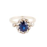 A SAPPHIRE AND DIAMOND CLUSTER RING