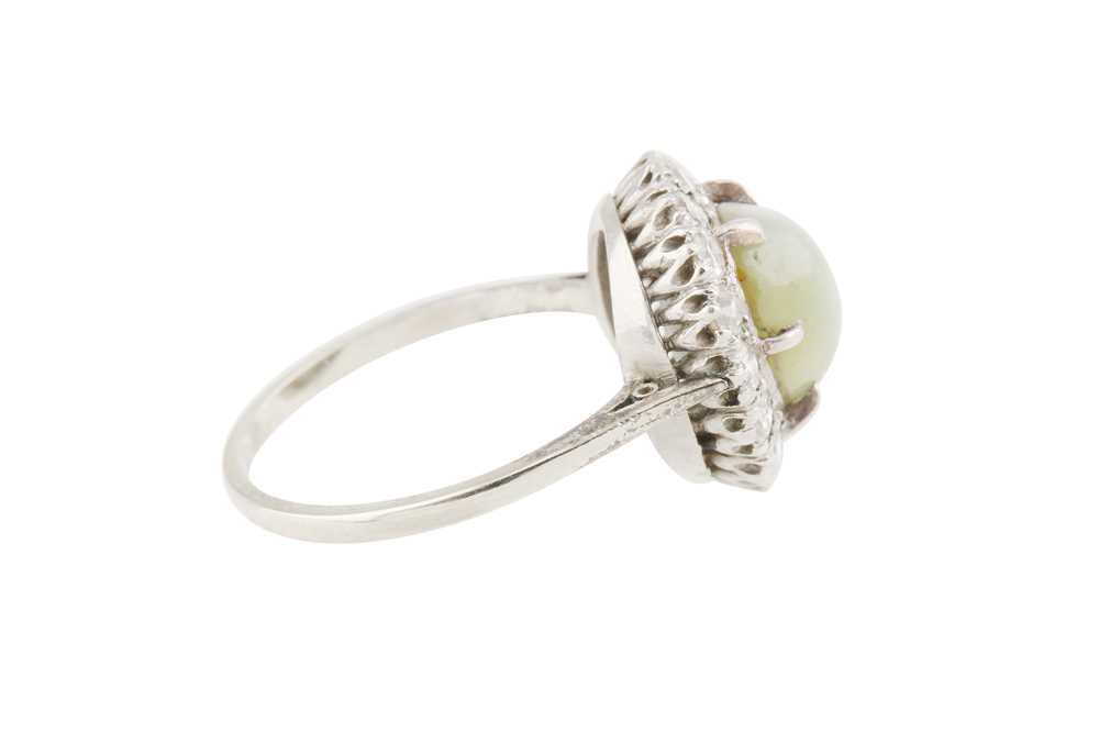 A CAT'S EYE CHRYSOBERYL AND DIAMOND CLUSTER RING - Image 3 of 4