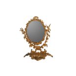 AN OVAL GILT METAL VANITY STAND MIRROR