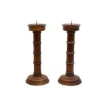 A PAIR OF TURNED OAK PRICKET CANDLESTICKS