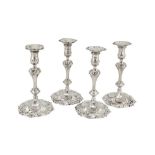 Two pairs of George III sterling silver cast candlesticks, London 1762 by Jacob Marsh and London 177