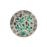 AN IZNIK POTTERY DISH WITH CARNATIONS AND TULIPS Ottoman Turkey, ca. 1580 - 1600