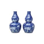 A PAIR OF CHINESE BLUE AND WHITE DOUBLE GOURD VASES.