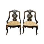 A PAIR OF LATE VICOTRIAN EBONISED AND MOTHER OF PEARL INLAID CANED CHAIRS