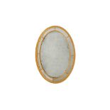 A GEORGE III OVAL GILT WALL MIRROR