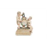 A BUEN RETIRO PORCELAIN PUTTI AND URN SCULPTURE