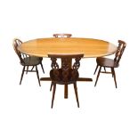 AN ERCOL ELM OVAL DINING TABLE