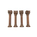 A SET OF EIGHT CARVED OAK COLUMNS