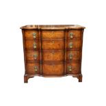 A FEATHERBANDED WALNUT SERPENTINE CHEST OF DRAWERS