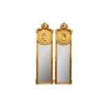 A PAIR OF ROCOCO STYLE GILDED LONG NARROW MIRRORS