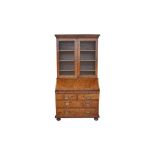 AN EARLY GEORGIAN WALNUT BUREAU BOOKCASE