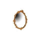 A CARVED OVAL GILTWOOD WALL MIRROR, 19TH CENTURY AND LATER