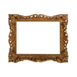 AN ENGLISH CARVED AND GILDED ROCOCO STYLE SWEPT AND PIERCED FRAME