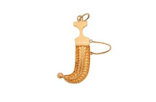 A SMALL GOLD PENDANT IN THE SHAPE OF A JAMBIYA DAGGER Possibly Kuwait or the South Arabian Gulf, sec