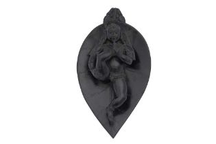 A CARVED BLACK STEATITE FIGURINE OF BAL KRISHNA SUCKING HIS TOE Possibly Sindh or Punjab, Northern I