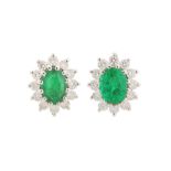 A PAIR OF EMERALD AND DIAMOND STUDS