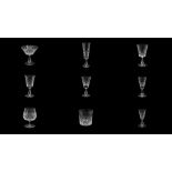 A SET OF WATERFORD CRYSTAL DRINKING GLASSES IN A DEVIATION OF THE LISMORE PATTERN