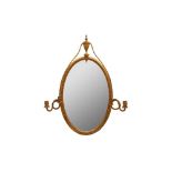 A GILT OVAL OVERMANTLE MIRROR