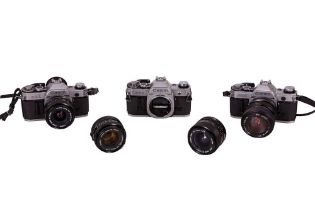 Three Canon AE-1 bodies with lenses.