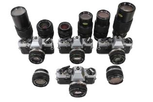 Four Olympus OM10 Outfits, Comprising 4 Bodies & 12 OM Lenses.