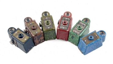 A Set of Six Coronet Midget Sub-Miniature Cameras.