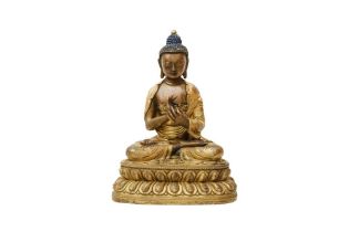 A SINO-TIBETAN PARCEL-GILT BRONZE FIGURE OF BUDDHA SHAKYAMUNI 清十八世紀 銅鎏金釋迦牟尼佛像