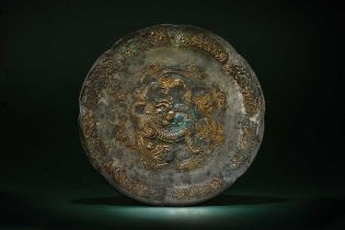 A CHINESE PARCEL-GILT SILVERED COPPER-ALLOY 'DRAGON' DISH 唐 銅合金局部鎏金龍紋八形盤